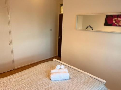 a room with a bed with two towels on it at Beautiful Rooms close to Brick Lane in London