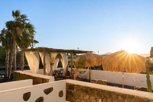 a resort with umbrellas and tables and chairs at la torre boutique rooms in Procida