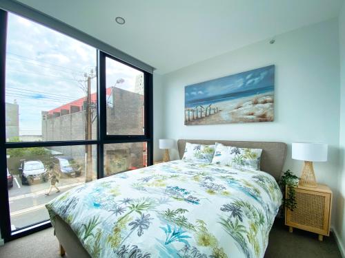 a bedroom with a bed and a large window at Stunning 2BR Apt @ Adelaide CBD with Pool-Gym-BBQ in Adelaide