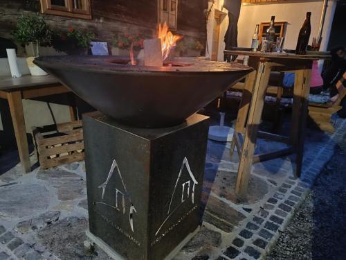 a fire pit in a room with a table at Ferienhaus Grabenhansl in Stubenberg