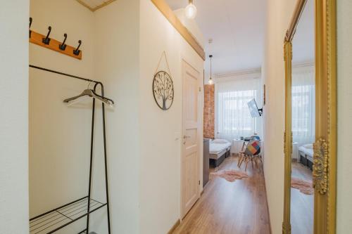 a hallway with a glass shower in a room at Filosoofi 1 Studio Apartments in Tartu