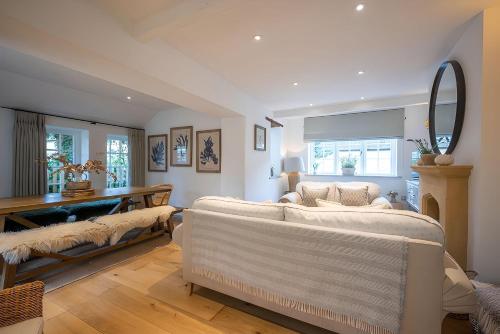 a living room with a couch and a mirror at High House in Chipping Campden