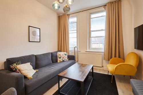 a living room with a couch and a table at Host & Stay - Cosy Twickenham Rugby Gem in Twickenham