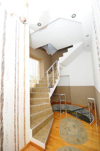 a staircase in an old building with a rug at Dzveli Batumi in Batumi