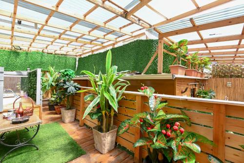 an outdoor patio with plants and a pergola at צימר הבקתה in Tiberias