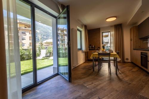 a kitchen and dining room with sliding glass doors at San Martin Holidays Home - Stay, Work & Fun in Pont-Saint-Martin