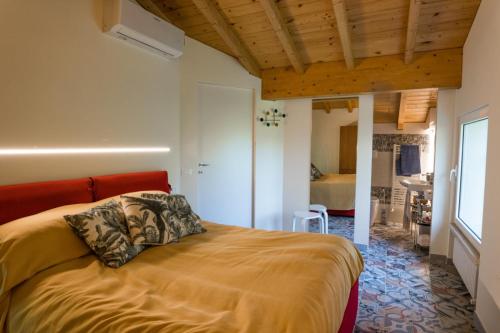 a bedroom with a bed with a orange headboard at Villa Silvana - Apt Giulia & Michela with terrace & parking in Perugia