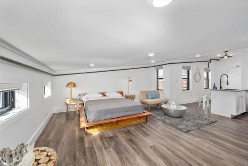a bedroom with a bed and a living room and a kitchen at Brand New on the Streetcar line in Cincinnati