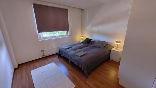 a bedroom with a bed and a large window at New 1 bedroom apartment near amenities nilsia near tahko in Nilsiä