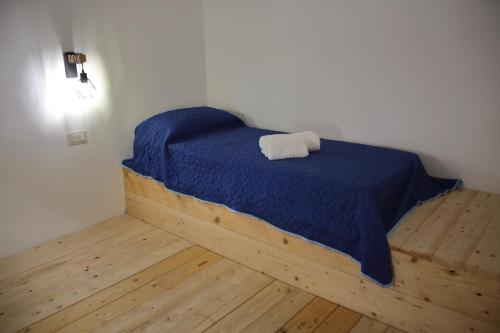 a bedroom with a bed with a blue comforter at B&B Domus Magma in Pompei