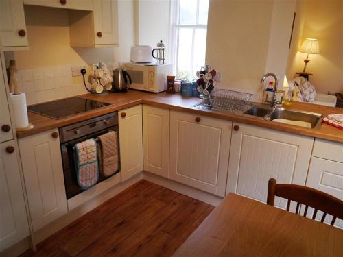 a kitchen with a sink and a stove top oven at Bogroy in Aberlour