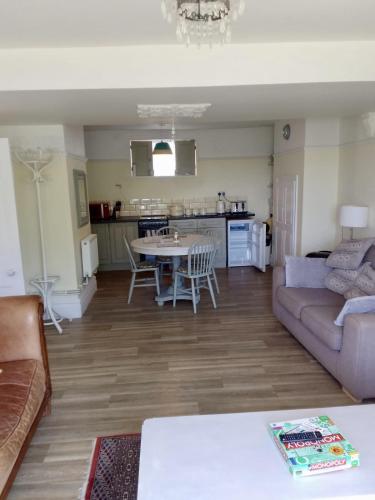 a living room with a couch and a table at St Marys Apartment in Hastings