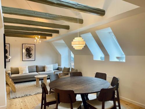 a living room with a table and a couch at Large apartment in Lovely Urban Area in CPH Ø in Copenhagen