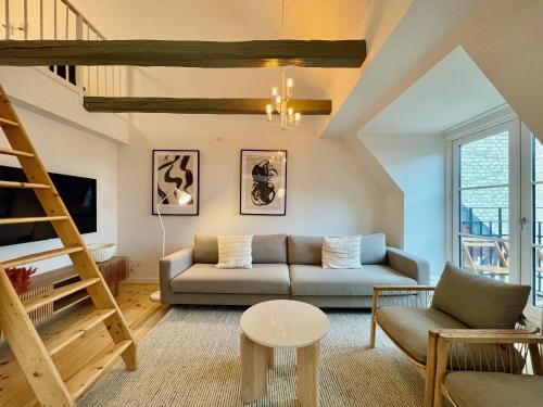 a living room with a couch and a ladder at Large apartment in Lovely Urban Area in CPH Ø in Copenhagen