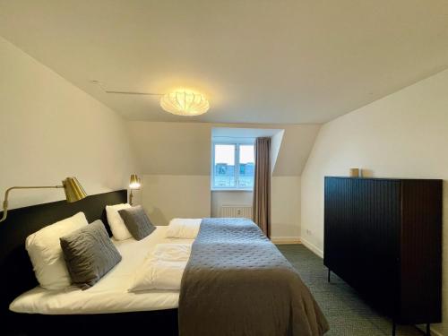 a bedroom with a large bed and a window at Large apartment in Lovely Urban Area in CPH Ø in Copenhagen