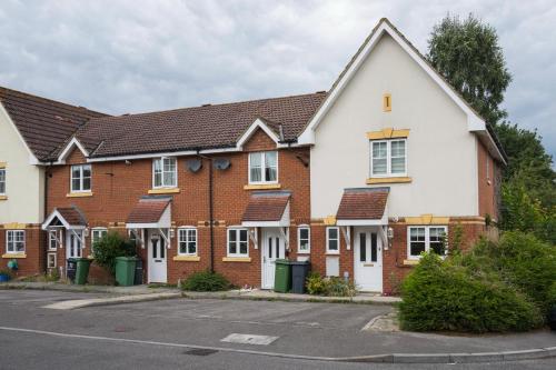 a row of brick houses in a parking lot at Maidstone villa 3 bedroom free sports channels,parking in Kent
