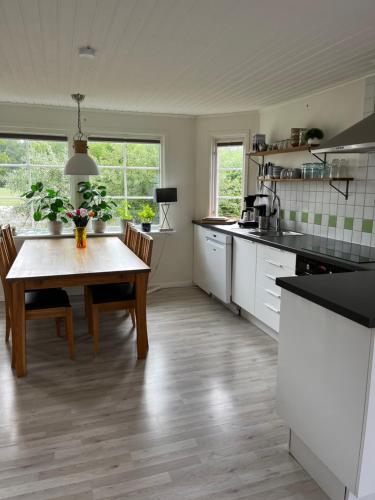 a kitchen with a table and a dining room at Fjällbacka Villa in Fjällbacka