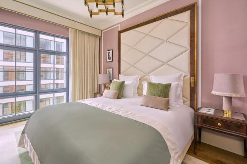a bedroom with a large bed and a large window at Hotel Barrière Fouquet's New York in New York