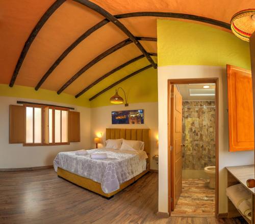 a bedroom with a bed and a shower at Hotel boutique casa Lily in Tunja