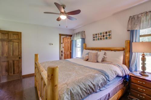 a bedroom with a bed and a ceiling fan at Spacious Cabin with Private Dock on Thompson Lake in Oxford