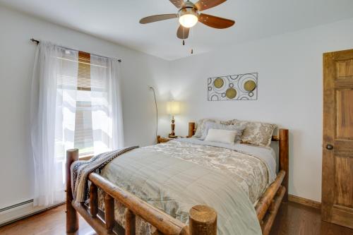 a bedroom with a bed and a ceiling fan at Spacious Cabin with Private Dock on Thompson Lake in Oxford