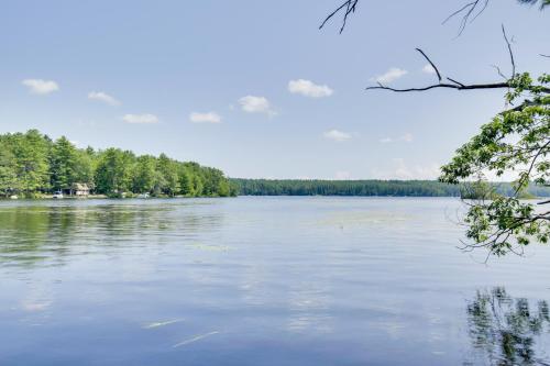 a view of a lake with trees in the background at Spacious Cabin with Private Dock on Thompson Lake in Oxford