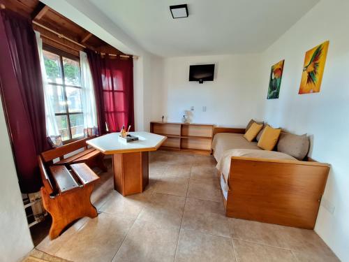 a living room with a couch and a table at Mirador de las Nieves in San Carlos de Bariloche
