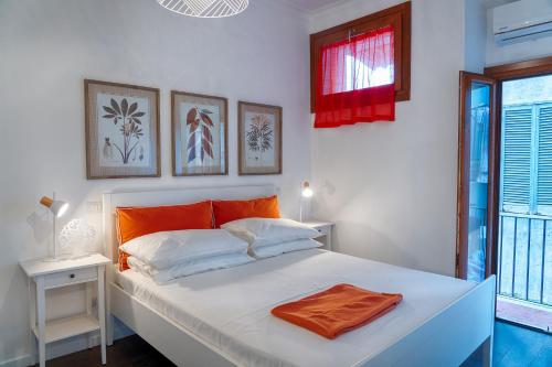 a bedroom with a white bed with an orange towel on it at Accogliente intero appartamento in Rome