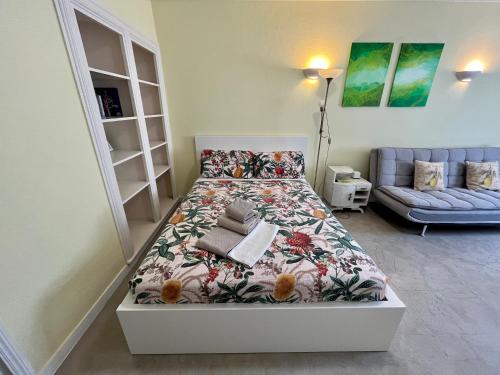 a small bedroom with a bed and a couch at Ljmonade Hostel in Cascais