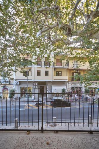 a fence in front of a street with a building at La Maison Apparthotel in Praia a Mare