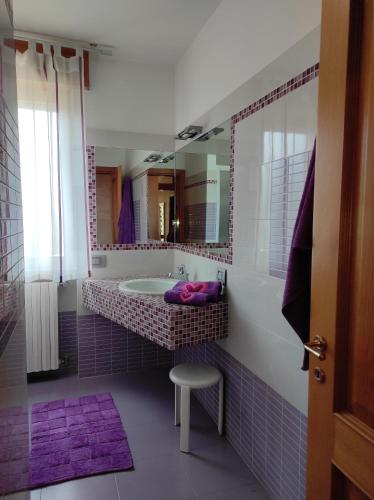 a bathroom with a tub and a sink and a mirror at Villa Pina in Ferrazzano