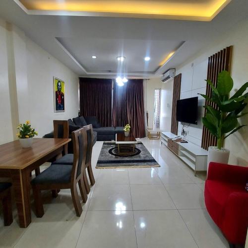 a living room with a table and a dining room at Ziroc Apartments Lekki Phase 1 in Lagos