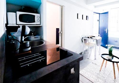a kitchen with a sink and a microwave at Superbe appartement Montélimar in Montélimar