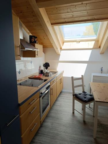 a kitchen with a sink and a stove top oven at Apartment unterm Dach mit kleinem Seeblick in Münsing