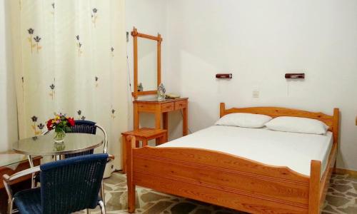 Ένα ή περισσότερα κρεβάτια σε δωμάτιο στο Πανσιόν Τζίνα