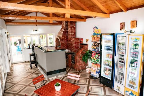 a grocery store with a counter and a brick fireplace at Pensiunea 77 