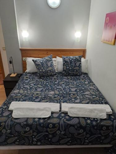 a bedroom with a bed with two pillows at Hotel Merino in Pas de la Casa