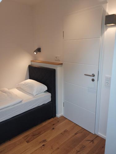 a small bedroom with a bed and a closet at Filder-Appartements in Filderstadt