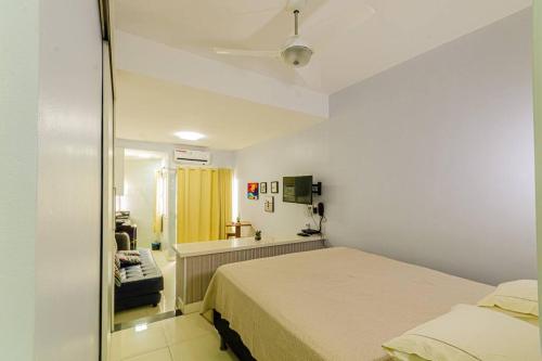 a small bedroom with a bed and a sink at Apartamento Incrível in Salvador