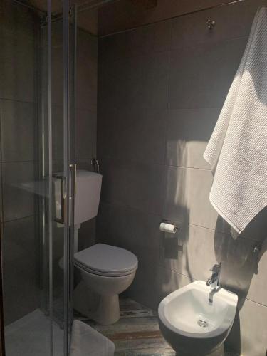 a bathroom with a toilet and a sink at CD Romanello (Mura S. Cataldo) in Barletta