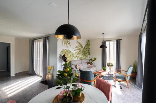 a living room with a couch and a table at Recreatiepark Maas en Bos in Wellerlooi