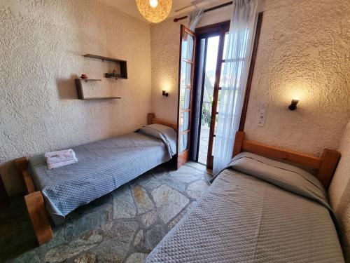 twee bedden in een kamer met een raam bij Evan's Suite in Glífa