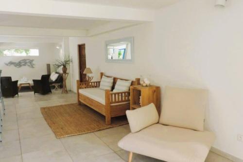a living room with a couch and a chair at MADRAS LODGE in Le Diamant