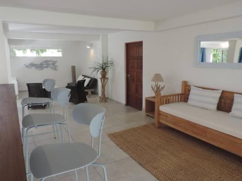a living room with a couch and tables and chairs at MADRAS LODGE in Le Diamant