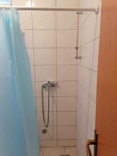 a bathroom with a shower with a shower curtain at Hostel Hercegovina in Mostar