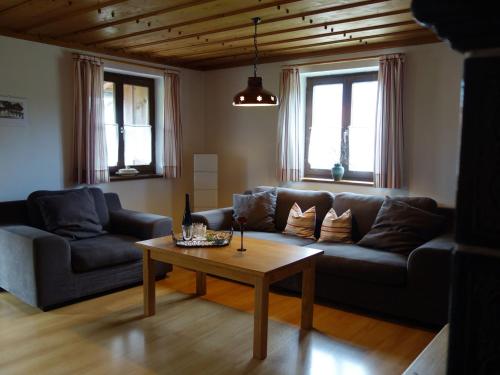 ein Wohnzimmer mit einem Sofa und einem Couchtisch in der Unterkunft Ferienwohnung Obermeier in Grassau