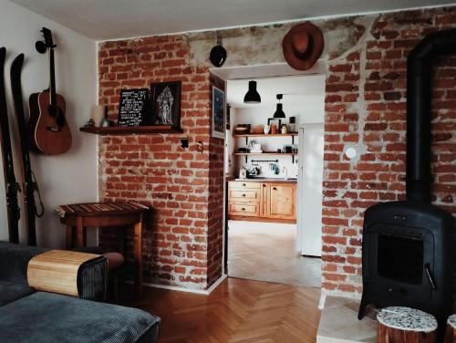 a living room with a brick wall and a stove at Old Town Apartment in Liptovský Mikuláš