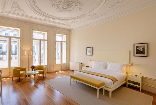 a bedroom with a large bed with a coffered ceiling at Casa do Arquiteto - Townhouse - Architect's House in Porto