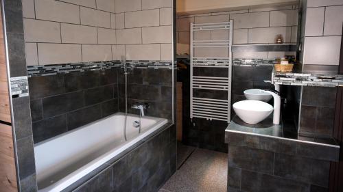 a bathroom with a bath tub and a toilet at La Sapinière St Lary Soulan in Saint-Lary-Soulan