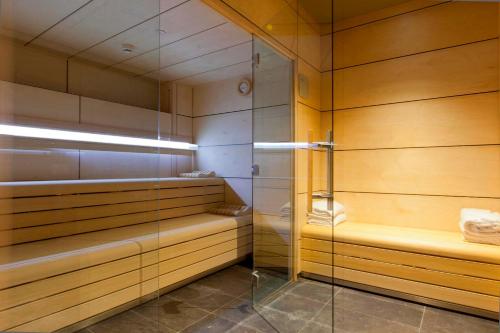 a sauna with wooden walls and a glass door at Hotel SB Plaza Europa in Hospitalet de Llobregat